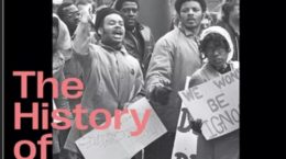 Black-and-white photo of protestors holding signs and a flag, with bold pink text overlaid that reads: The History of Black Studies Abdul Alkalimat. This powerful image highlights the roots of African American studies. The background is framed in black.