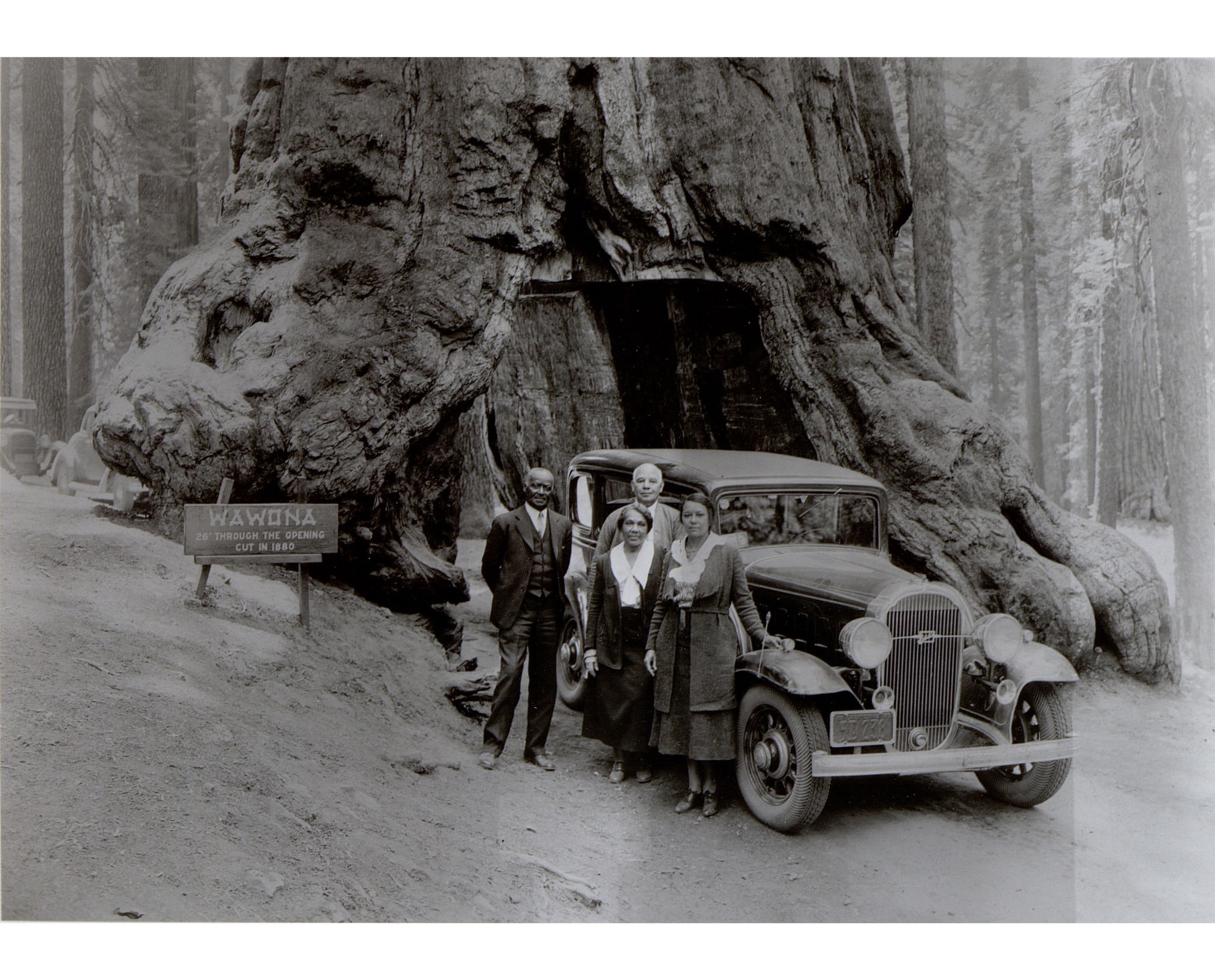 Titus Alexander with his wife Mary Alexander, at the Wawona Tree, Yosemite National Park, California, ca. 1920–30. Miriam Matthews Photographic Collection. Courtesy Library Special Collections, Charles E. Young Research Library, UCLA. Titus Alexander with his wife Mary Alexander, at the Wawona Tree, Yosemite National Park, California, ca. 1920–30. Miriam Matthews Photographic Collection. Courtesy Library Special Collections, Charles E. Young Research Library, UCLA. Titus N. Alexander (center) and his wife Mary Alexander (right) stand with another couple in front of the Wawona Tree, a famous giant sequoia that stood in Mariposa Grove at Yosemite National Park until a snowstorm brought it down in 1969. At the time of this photograph, the “See America First” campaign was promoting travel to national parks via western railroad lines and automobile tourism in the mass media, including in Black-owned publications. Traveling in the 1920s, before Black travel guide publications were available, this adventurous and resourceful African American group had to find places for food and lodging that would serve them along their scenic drive to Yosemite—three hundred miles and at least a day's drive from Los Angeles when freeways were not yet constructed and dirt roads were still prevalent. An enthusiast for fishing and hunting as well as visiting California nature sites, Alexander was originally from Arkansas. He was educated at Oberlin College in Ohio before moving to Los Angeles in 1897 where he became a civic leader and community historian whose work life career spanned both the public and private sectors. In the 1920s, he attempted to build an amusement center for African Americans at a beach area near the City of El Segundo, but his plans were sabotaged by racist White civic leaders who mounted a months-long campaign that eventually blocked the project.