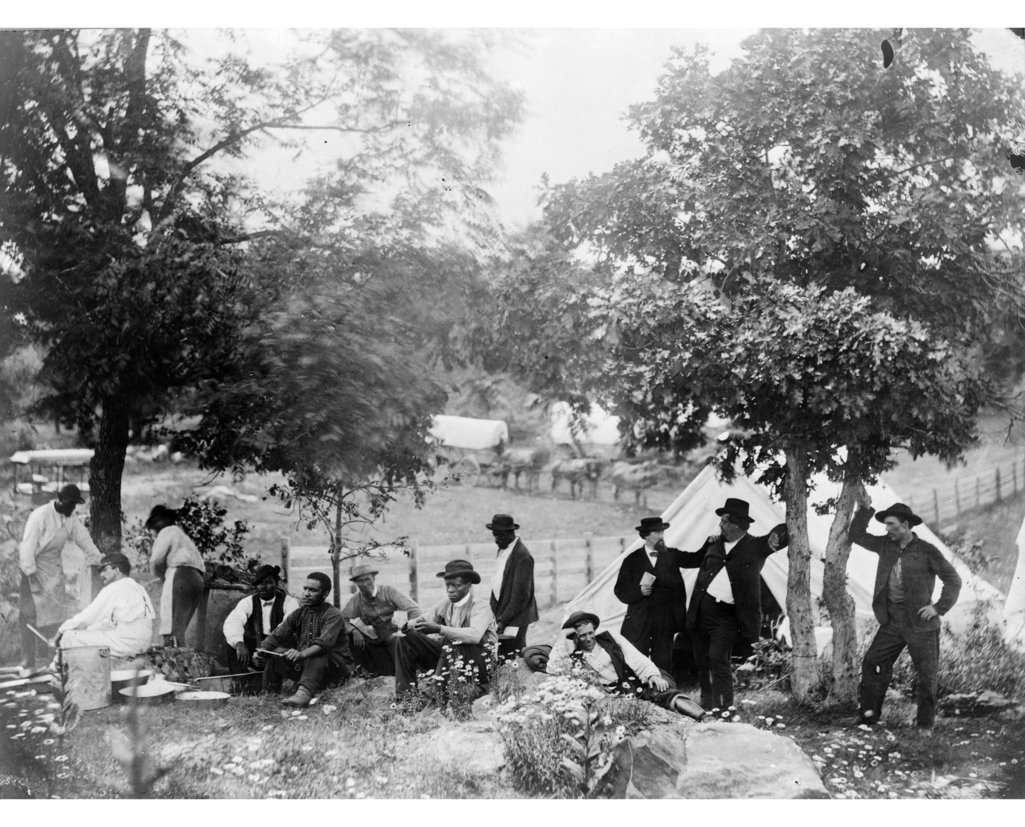 Gettysburg camp of Captain Huft, Gettysburg National Military Park, Pennsylvania, c. 1865. Photo by Alexander Gardner. Gettysburg National Military Park, Pennsylvania/Civil War Photograph Collection/Library of Congress. Gettysburg camp of Captain Huft, Gettysburg National Military Park, Pennsylvania, c. 1865. Photo by Alexander Gardner. Gettysburg National Military Park, Pennsylvania/Civil War Photograph Collection/Library of Congress. Black and White men are participating in the commemoration celebration and enjoying the outdoors at the laying of cornerstone of the Soldier’s National Monument on the anniversary of the Battle of Gettysburg. Men on left are preparing food.